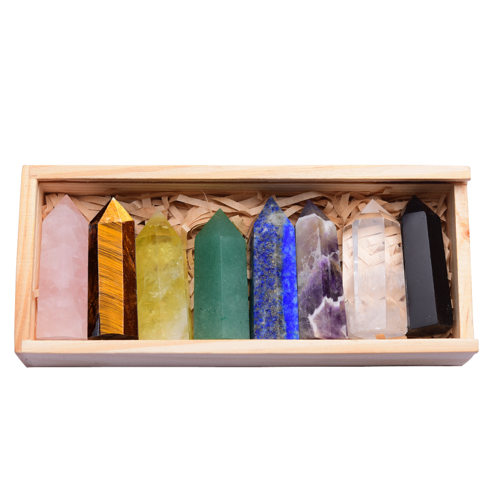Seven chakra crystal points in rainbow colors in a wooden box